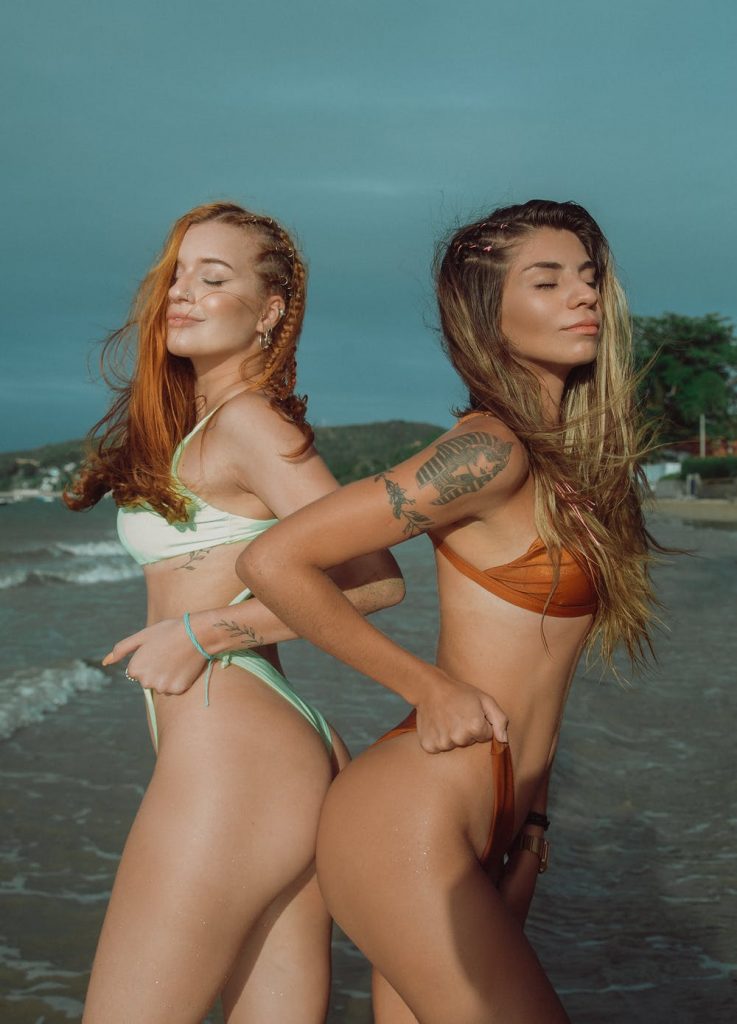 Two women flexing their bikini
